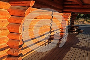 Metal bench in log cabin porch under evening sun light