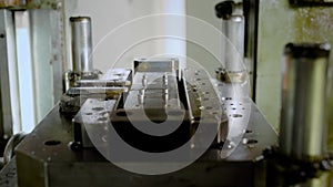 Metal bending machine in process, bending small metal sheets.