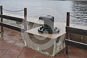 Metal berth for ships at sea. Rusty Mooring Bollard. Mooring in the port, with the sea in the background