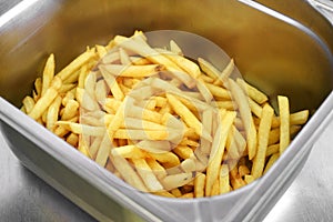 Metal bin filled with golden crispy potato chips