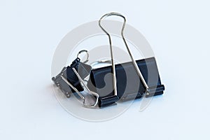 Metal Black Paper clip big on white background. Office equipment or school equipment.