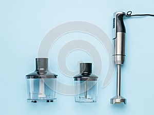 Metal blender for whipping and chopping on a blue background