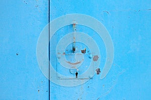 metal blue door with padlock. Old garage gates with keyhole