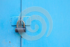 metal blue door with padlock. Old garage gates with keyhole