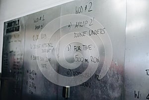 Metal board with written crossfit exercises