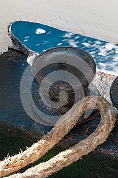 Metal bollard with mooring rope on ferry