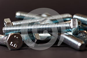 Metal bolts isolated on dark background