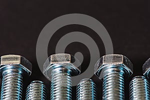 Metal bolts isolated on dark background