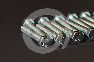 Metal bolts isolated on dark background