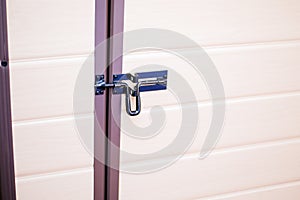 Metal bolts or latches in wooden door close-up