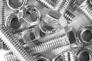 Metal bolts and nuts  in a row background. Chromed screw bolts and nuts . Steel bolts and nuts pattern. Set of Nuts and bo