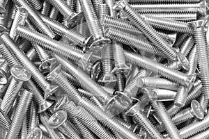 Metal bolts a row background. Chromed screw bolts texture. Steel bolts pattern. Set of bolts. Tools for work