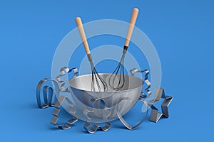 Metal bowl and cookie cutters with kitchen utensil on blue background
