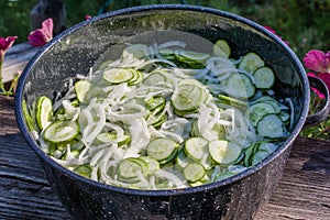 Metal bowl with sliced pickles