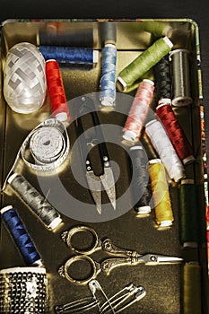 A metal box with sewing utensils