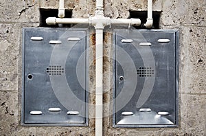 Metal boxes embedded in the wall to protect gas counters.