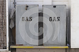 Metal boxes for gas meters placed on a wooden surface