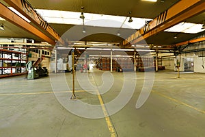 Metal bridge crane of great tonnage in a factory with a storage area photo