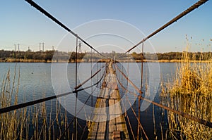 A metal bridge over the reeds. Lake and reeds