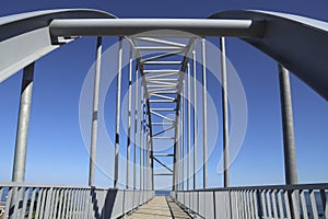 Metal bridge support, traffic line and pedestrian lane of new iron bridge under road. Black sea on background. Trabzon, Turkey