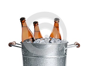 Metal bucket with bottles of beer and ice cubes isolated