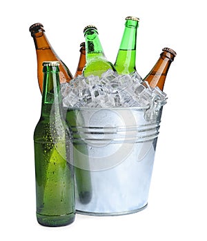 Metal bucket with bottles of beer and ice cubes isolated