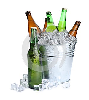 Metal bucket with bottles of beer and ice cubes isolated