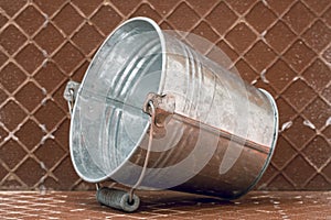 Metal bucket on the reverse side of the ceramic tile