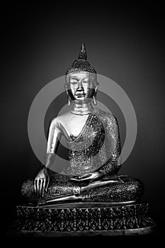 Metal Buddha statue full in black and white