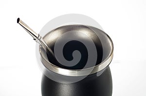 Metal calabash and bombilla on white background