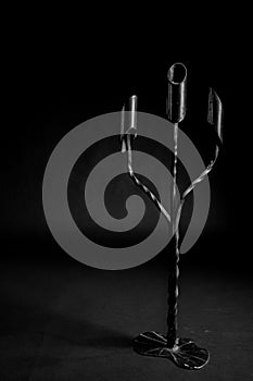 Metal candlestick on black background photo