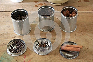 Metal canisters with spices for mulled cider