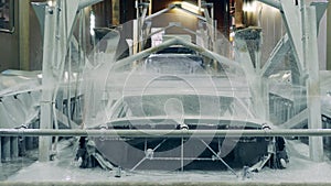 Metal car body is put in chemical solution.