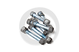 Metal car bolts with nuts used on a white isolated background in a photo studio. Spare consumables for auto repair in a garage or