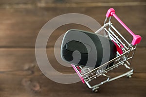 A metal cart from the supermarket with a computer mouse. The concept of shopping on the Internet