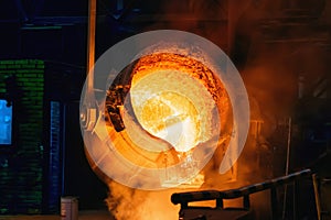 Metal Casting process in Foundry, Molten Iron pours from ladle to Blast Furnace