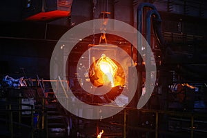 Metal casting process in metallurgical plant. Liquid metal pouring into molds