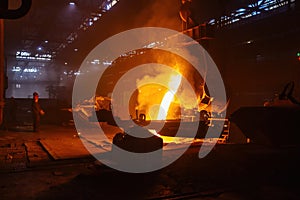 Metal casting process in metallurgical plant. Liquid metal pouring into molds