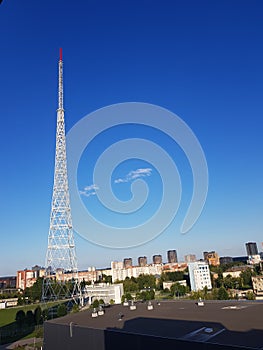 Metal cell tower against the blue sky