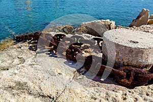 A metal chain attached to the bollard at port