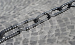 A metal chain on a grey background