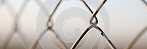 Metal chain links wire-mesh rabitz on blurred background