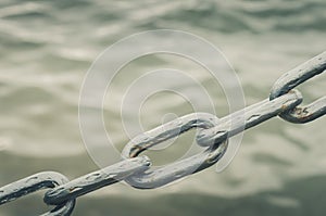 Metal chain on water background/metal chain on water background. Copy space