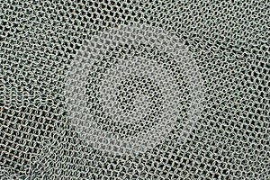 Metal chainmail ring pattern background close up