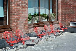 Metal chairs near brick wall