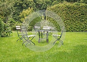 Metal chairs and a table in a public park