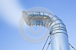 Metal chimney of a geothermal power station with stainless steel pipe structure with smoke and steam