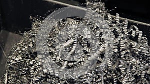 Metal chips fall after metalworking. Heap of metal shavings. Iron swarf