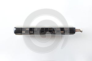 Metal chromatic harmonica isolated on white table top view