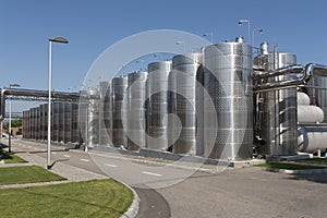 Metal chrome cask for wine photo. Stainless steel pipes and barrels as part of winery equipment